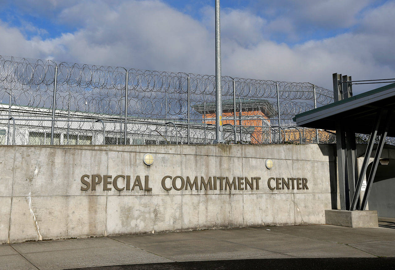 This 2015 photo shows the main entrance to Washington state’s Special Commitment Center next to a fence lined with razor wire on McNeil Island. (AP Photo/Ted S. Warren, File)