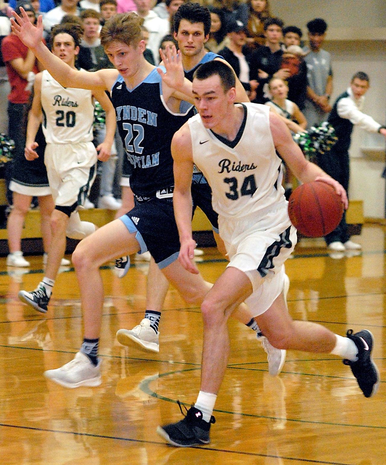 Port Angeles’ Liam Clark, right, races down court as Lynden Christian’s Cole Bajema keeps pace Saturday evening at Port Angeles High School. Lynden Christian, the defending state 1A champion and the No. 1-ranked 1A team in the state, won 64-50. The Roughriders are back in action at home at 7:15 p.m. Tuesday against Sequim, with the girls’ PA-Sequim game beginning at 5:45 p.m. (Keith Thorpe/Peninsula Daily News)