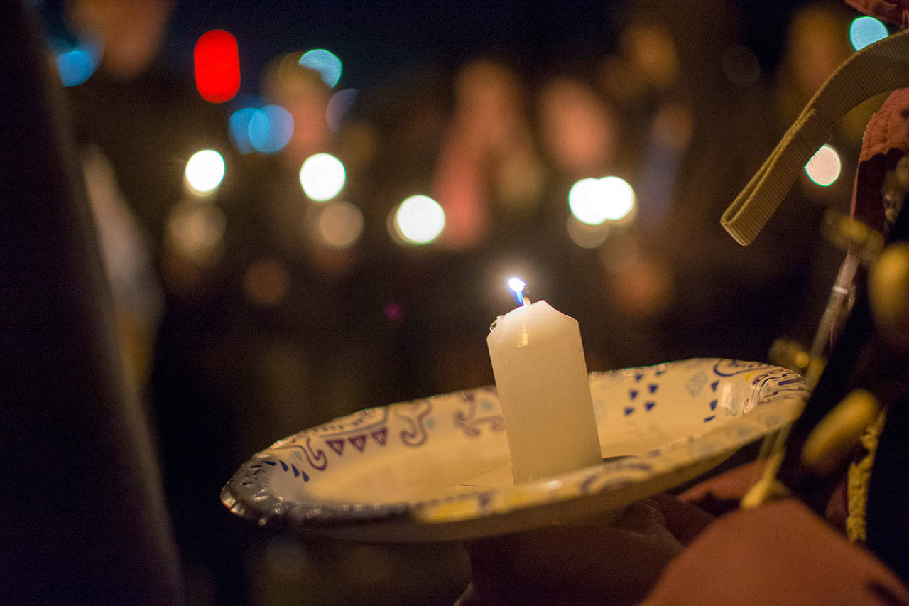 Candlelight illuminated Jessie Webster Park on Monday night as family and friends shared laughter and tears remembering Tiffany May, her longtime boyfriend Jordan Iverson, 27, and his father, Darrell Iverson, 57. (Jesse Major/Peninsula Daily News)