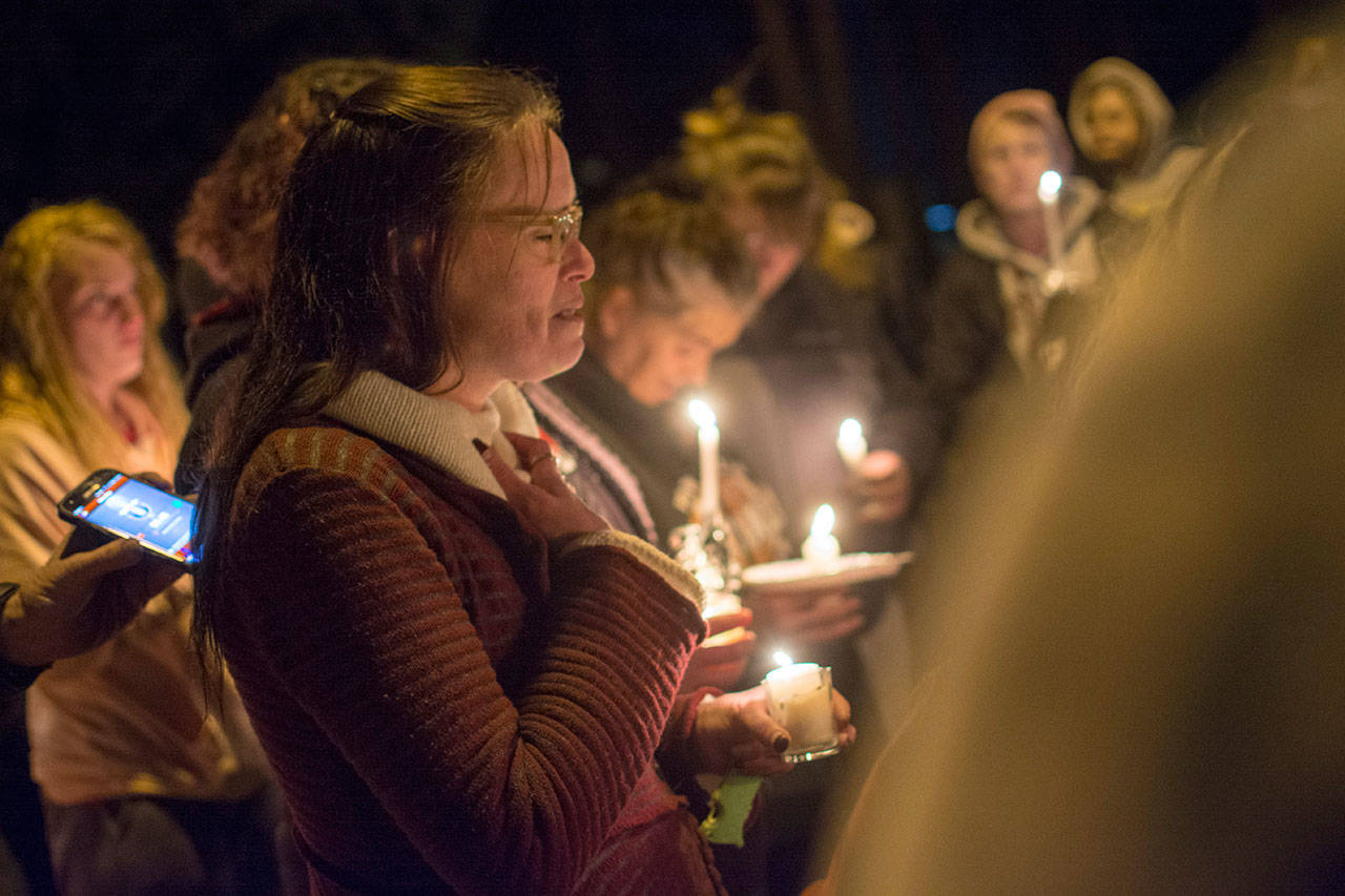 Siouxzie Hinton says a prayer at the begining of a candlelight vigil Monday. (Jesse Major/Peninsula Daily News)