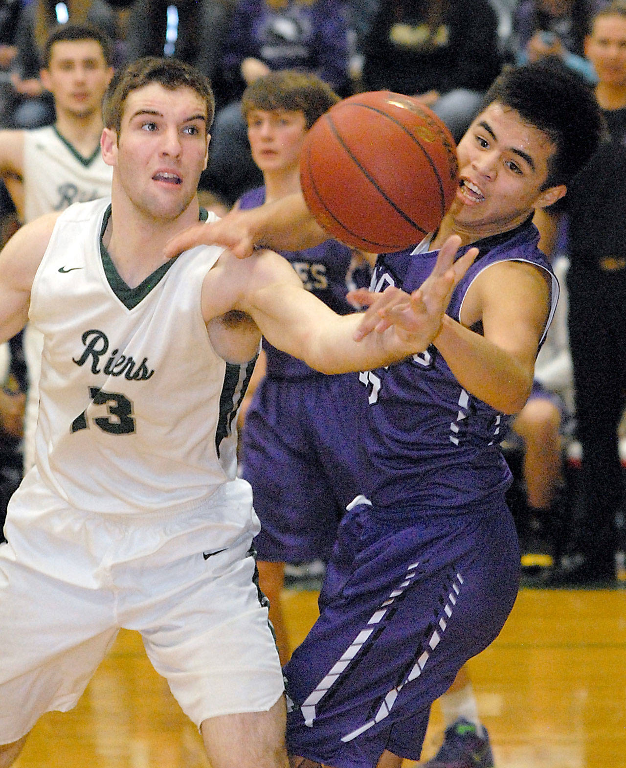 Keith Thorpe/Peninsula Daily News Port Angeles’ Garrett Edwards, right, fights for a rebound with Sequim’s Rigo Langston during the second quarter on Tuesday in Port Angeles.
