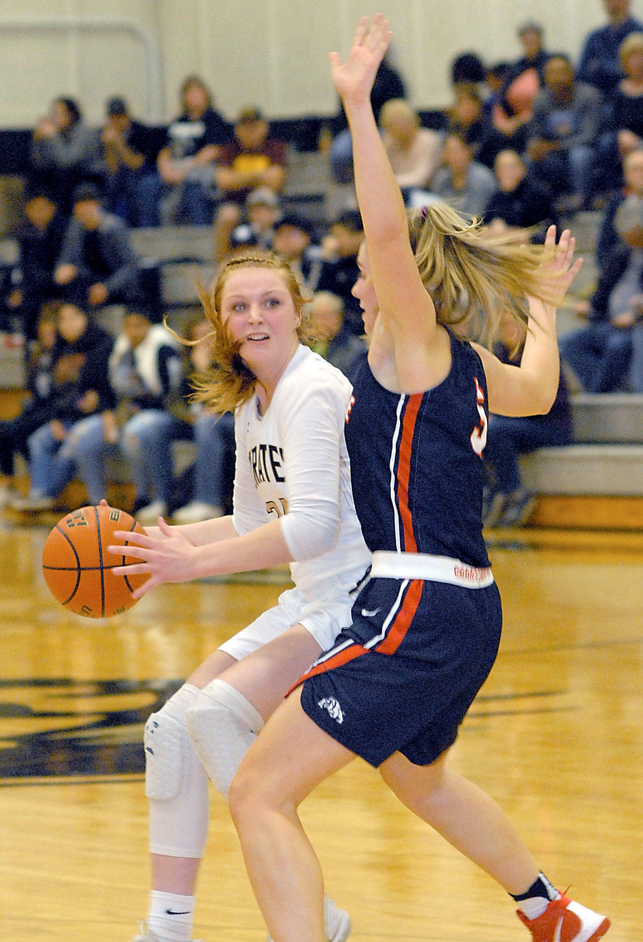 Keith Thorpe/Peninsula Daily News                                Peninsula’s Kameron Bowen, left, looks around the defense of Bellevue’s Natalie Amos in the third quarter on Wednesday night in Port Angeles.