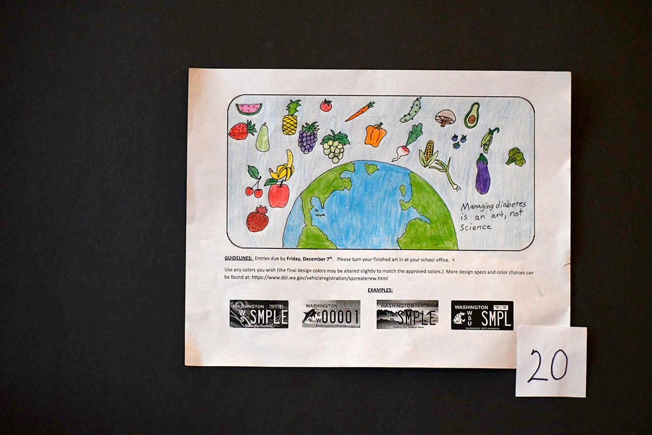 Fruits and vegetables circling the Earth was the winning design for a special-issue license plate competition focusing on diabetes prevention. Amelia Rose Kauzlarich, an eighth-grader at Blue Heron Middle School, said she entered the contest because diabetes has been part of her family. (Jeannie McMacken/Peninsula Daily News)