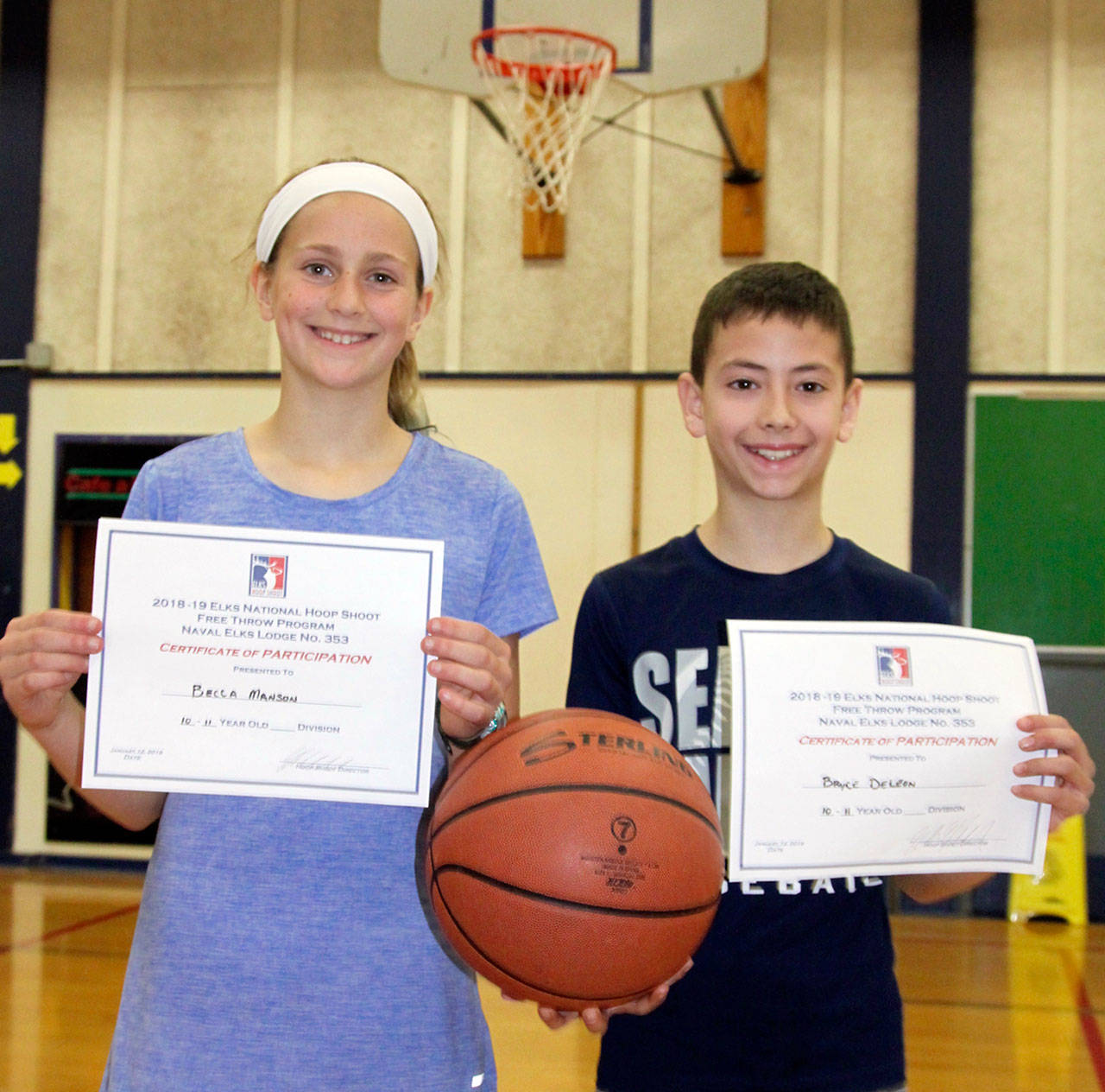 Dave Logan/for Peninsula Daily News The annual Port Angeles Naval Elks Lodge Elks Hoop Shoot contest was held Saturday at Stevens Middle School. Becca Manson, left, who made 5 of 25 shots and Bryce DeLeon who sank 18 of 25 shots are the 10-11 year old winners. DeLeon won his age group for the third straight year.