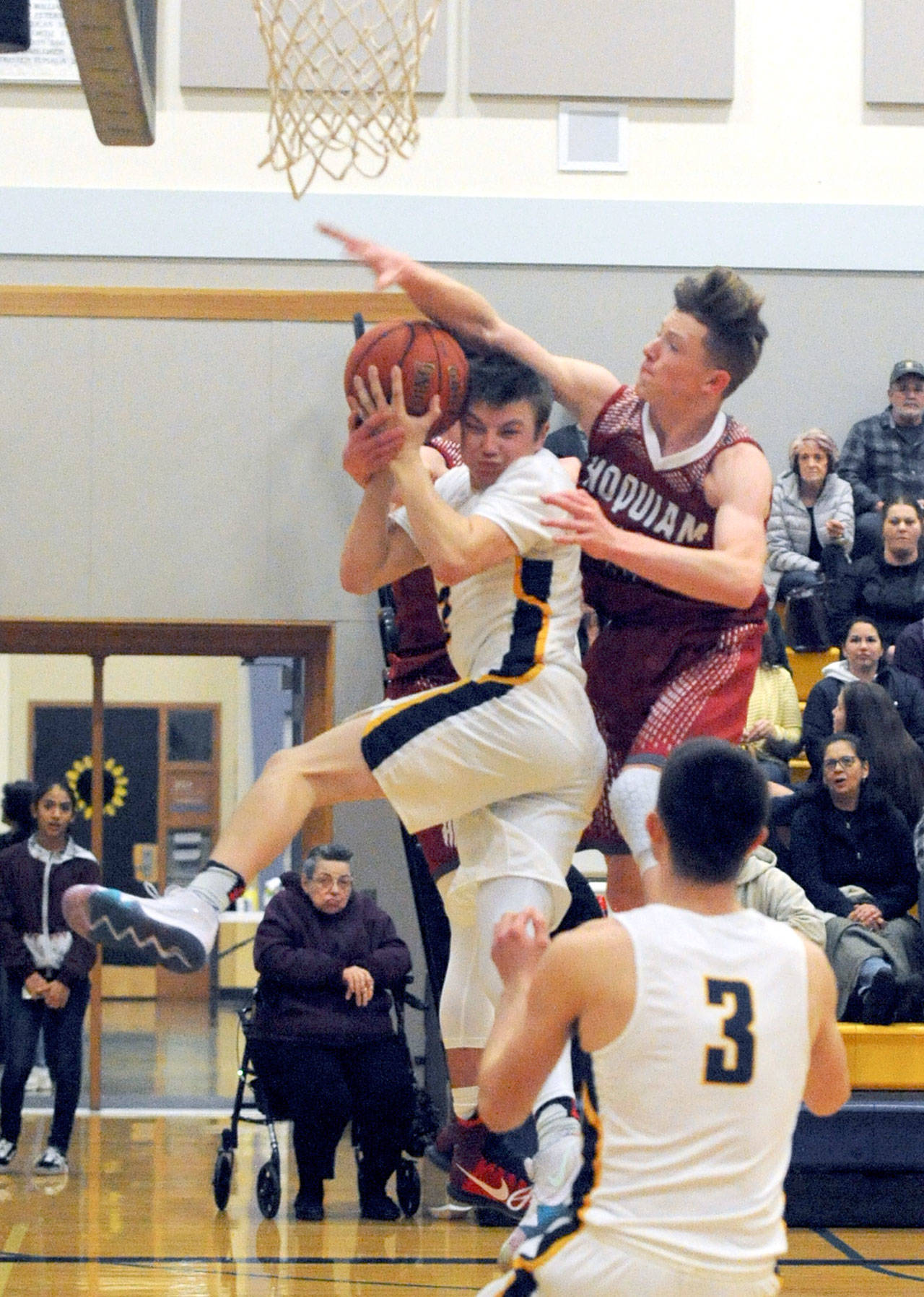 Spartan Joseph Reaume is fouled by Hoquiam’s Cameron Brumstead Tuesday night in Forks in this league contest won by Forks 62 to 60. Lonnie.