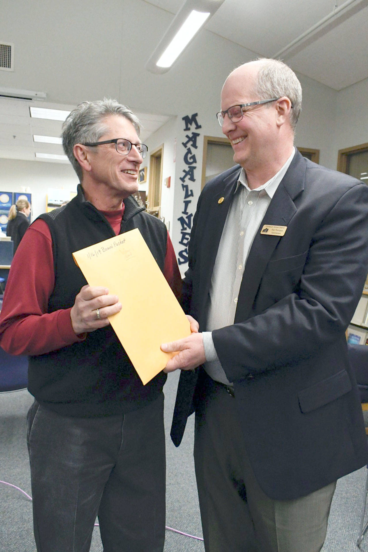 Mike Raymond of Port Ludlow, left, talks with Chimacum School Superintendent Rick Thompson after Raymond was appointed to the School Board. (Jeannie McMacken/Peninsula Daily News)