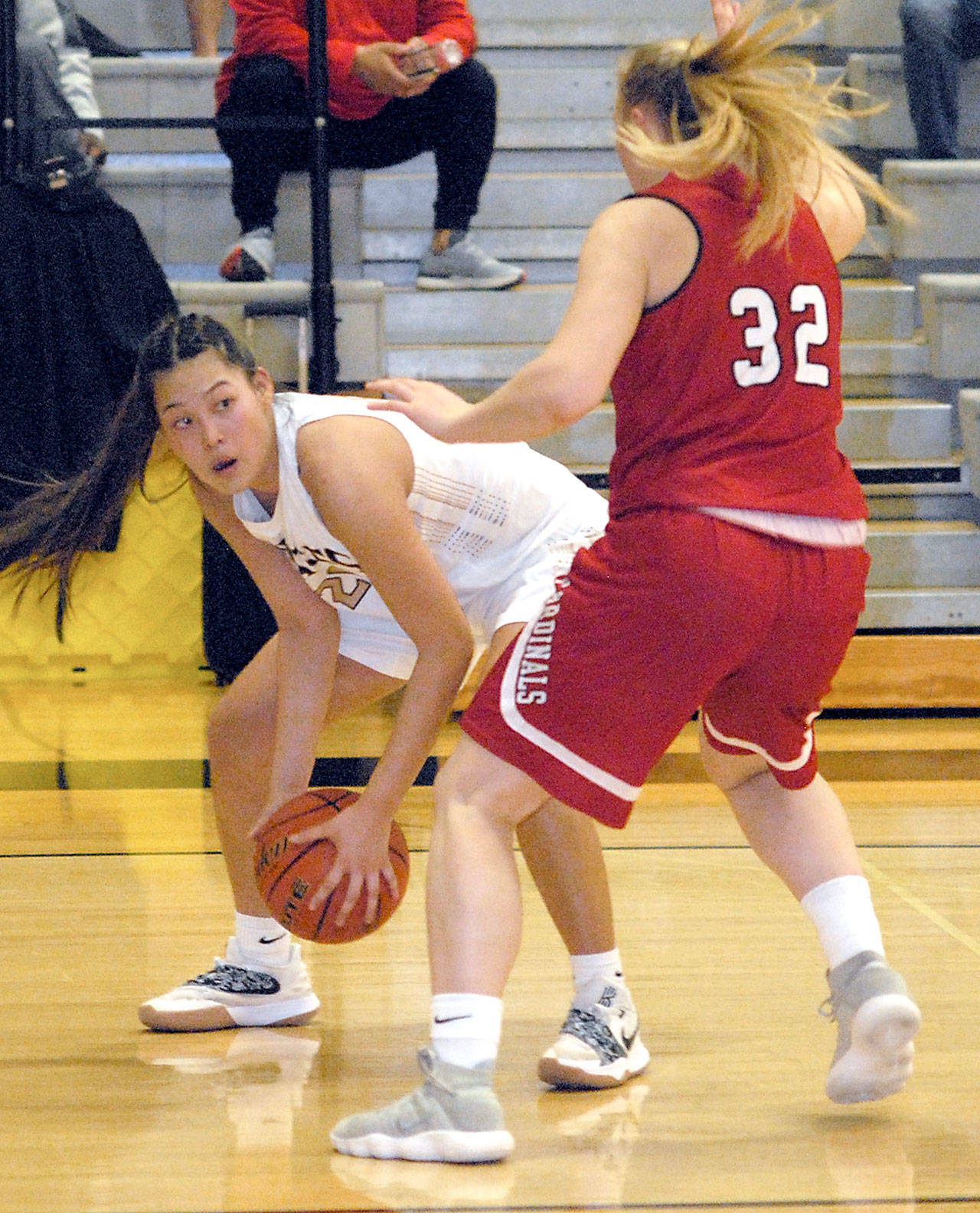 Keith Thorpe/Peninsula Daily News Peninsula’s Logan Luke, left, looks for a way around the defense of Skagit Valley’s Kaitlyn Meek, a graduate of Port Townsend High School, during Wednesday night’s game in Port Angeles.
