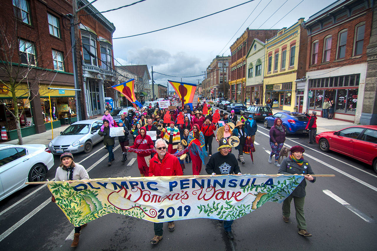 An estimated 1,000 people march down Water Street in Port Townsend during the third annual Olympic Peninsula Womxn’s Wave on Sunday. (Jesse Major/Peninsula Daily News)