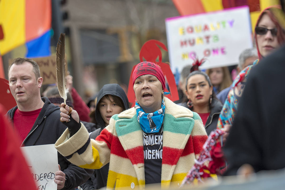 Sabrina McQuillen Hill, a Makah tribal member who lives in Port Townsend, marches down Water Street during the third annual Olympic Peninsula Womxn’s Wave on Sunday. (Jesse Major/Peninsula Daily News)