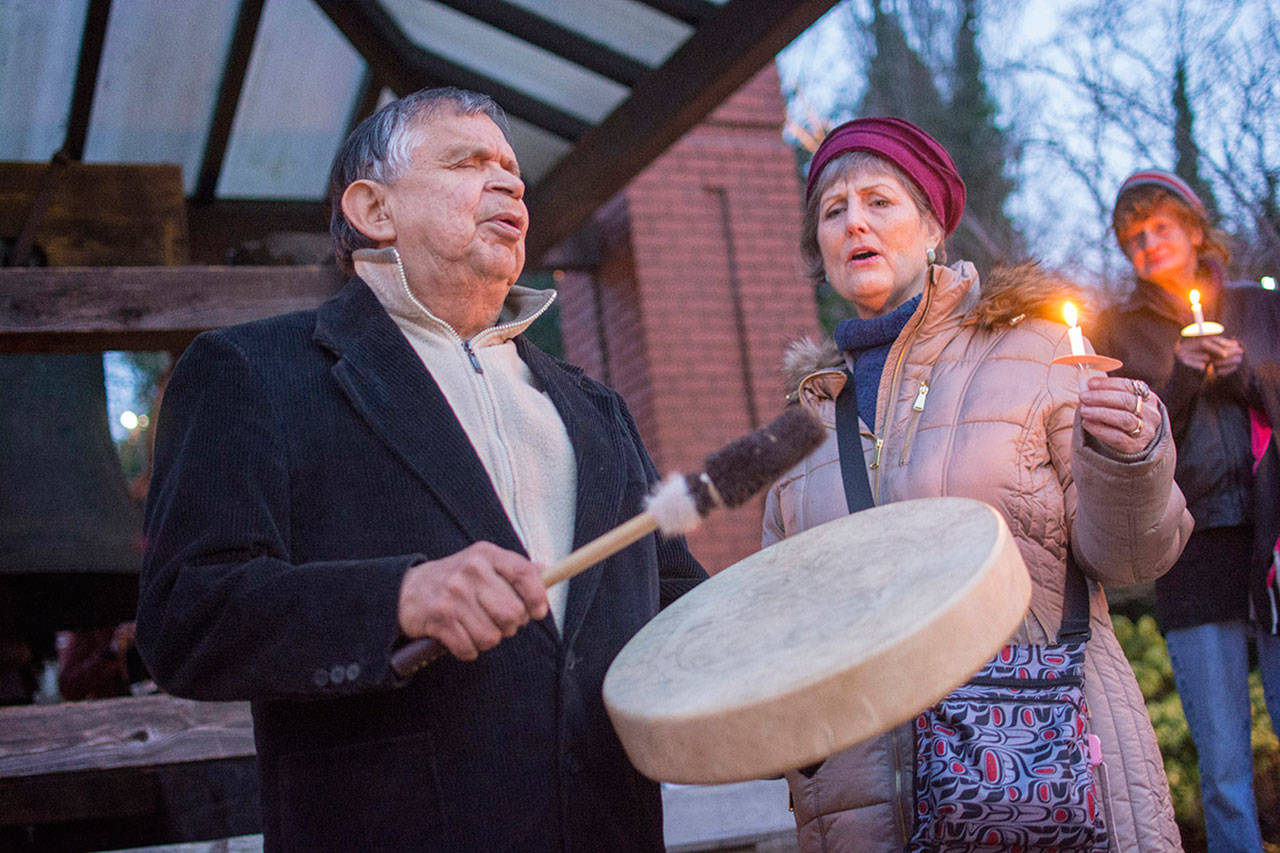 Virgil and Valerie Johnson of the Makah Tribe sing during a vigil for Valerie Claplanhoo on Monday evening. (Jesse Major/Peninsula Daily News)