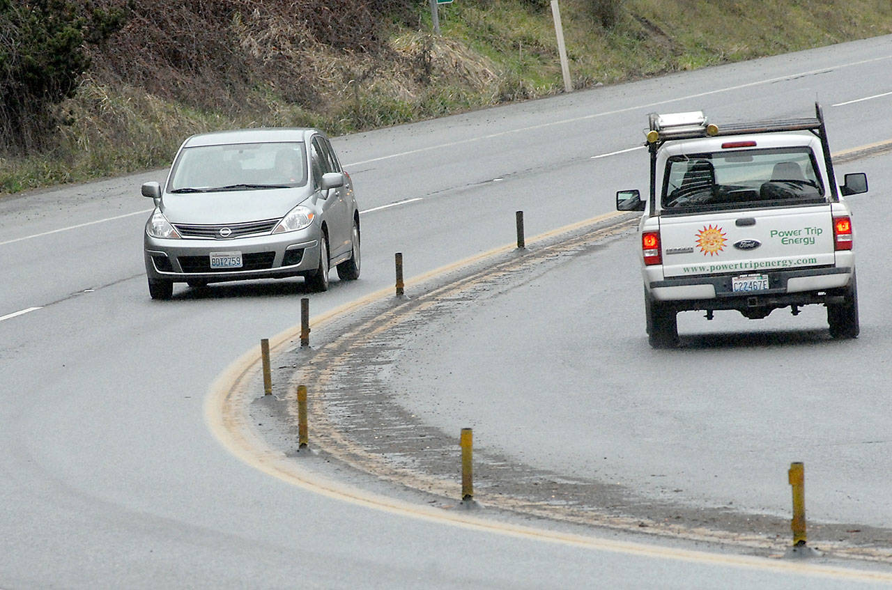 A centerline rumble strip and a line of weathered lane markers divide opposing lanes of traffic on U.S. Highway 101 on the approaches to Morse Creek east of Port Angeles. (Keith Thorpe/Peninsula Daily News)