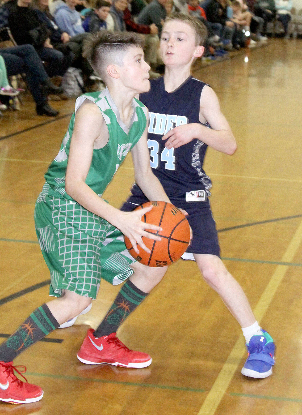 Alex Angevine of the Port Angeles sixth-grade boys team gets ready to shoot over the defense of the Gig Harbor Tides at this weekend’s Martin Luther King Jr. tournament in Port Angeles. Port Angeles went on to win the game Sunday 46-30. (Dave Logan/for Peninsula Daily News) )