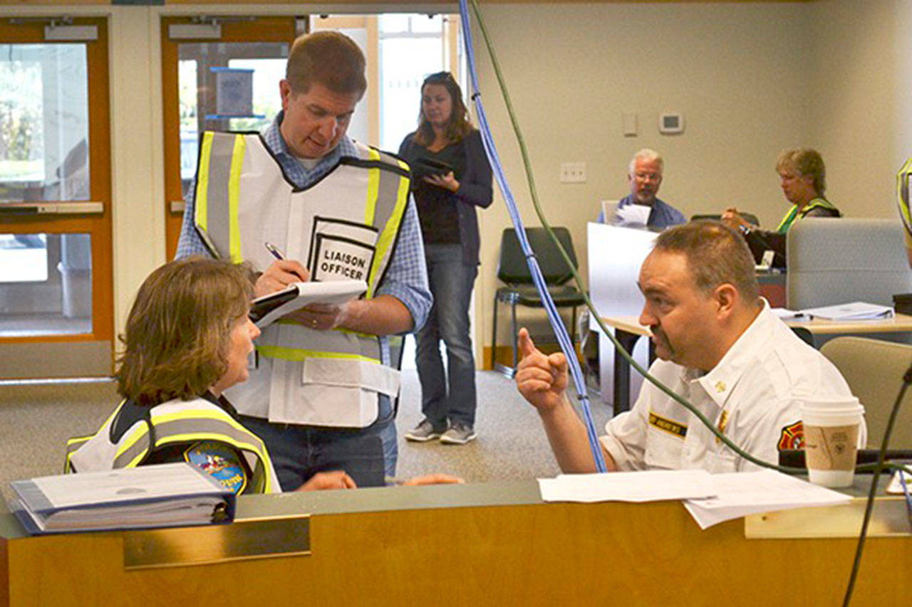 A new agreement between the city of Sequim and Clallam County Fire District No. 3 allows for more joint emergency training and job sharing during an incident at the Emergency Operations Center in the Sequim Transit Center, seen here in June 2016 with Sequim City Manager Charlie Bush, Sequim Police Chief Sheri Crain and Fire Chief Ben Andrews. (Matthew Nash/Olympic Peninsula News Group)