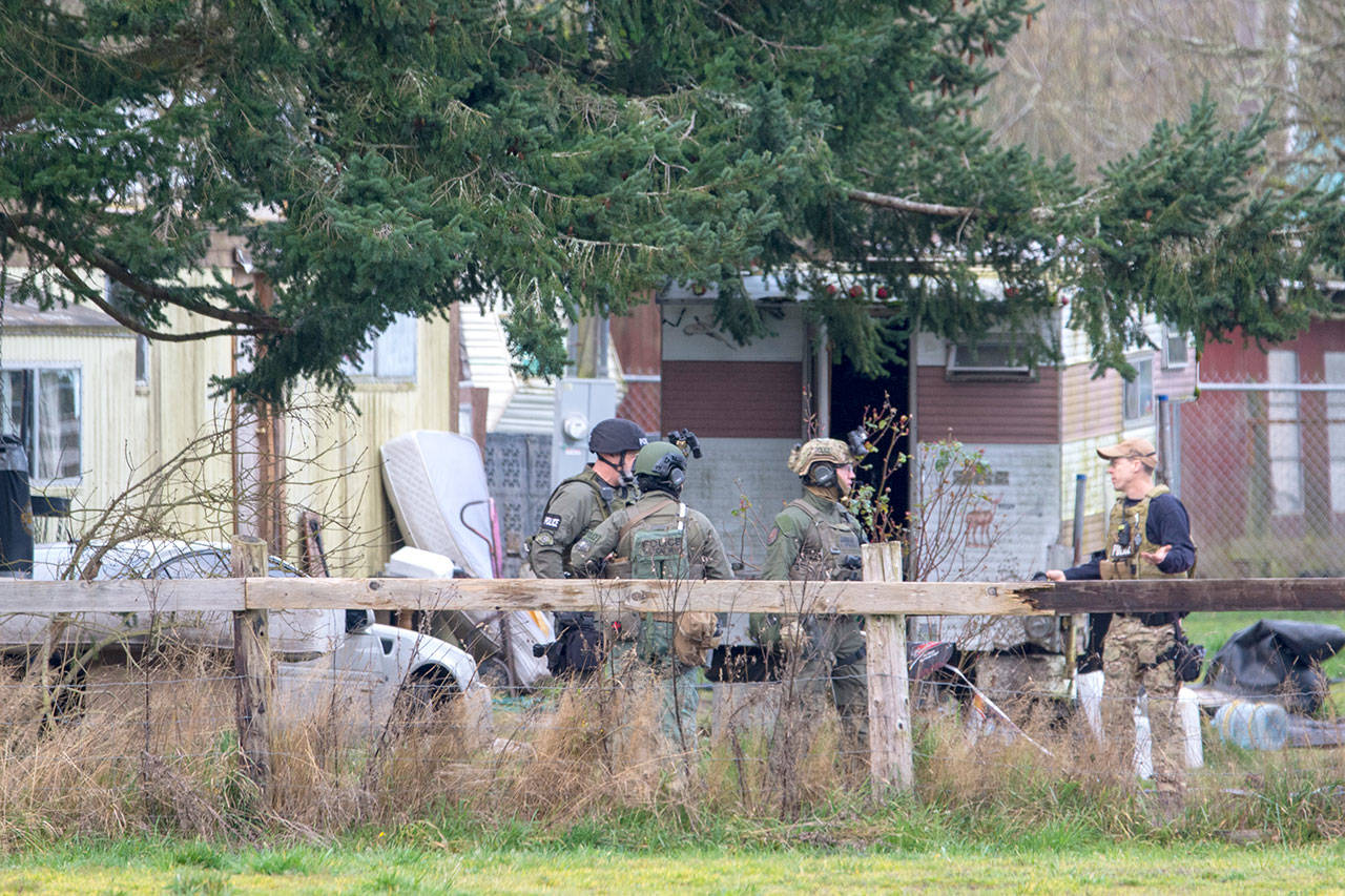 Members of the State Patrol SWAT team executed a search warrant on a property on Lower Elwha Road where a man was arrested in connection to the triple homicide. (Jesse Major/Peninsula Daily News)