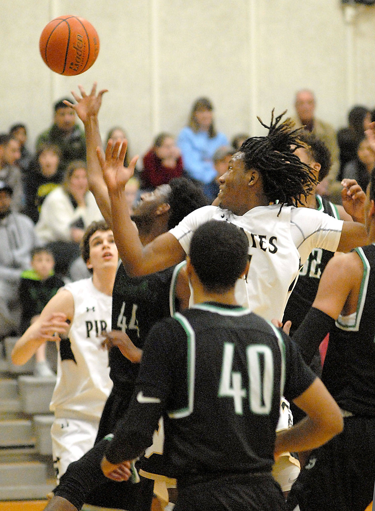 Keith Thorpe/Peninsula Daily News Peninsula’s Malik Moore, center, vies for a rebound with Shoreline’s Dawit Nuguse on Wednesday night in Port Angeles, Looking are Peninsula’s Luke Angevine, left, and Shoreline’s Keilyn Myers, front.