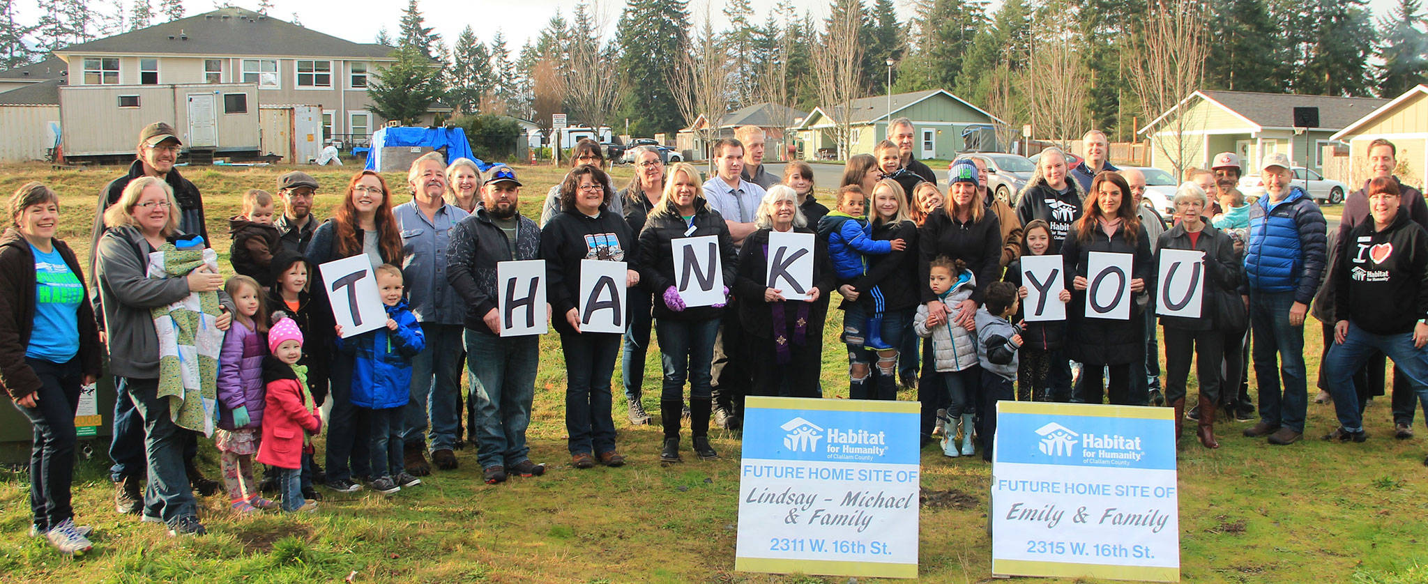 Community members gather together to commemorate breaking ground on two new homes in Port Angeles for two local families. (Habitat for Humanity of Clallam County)