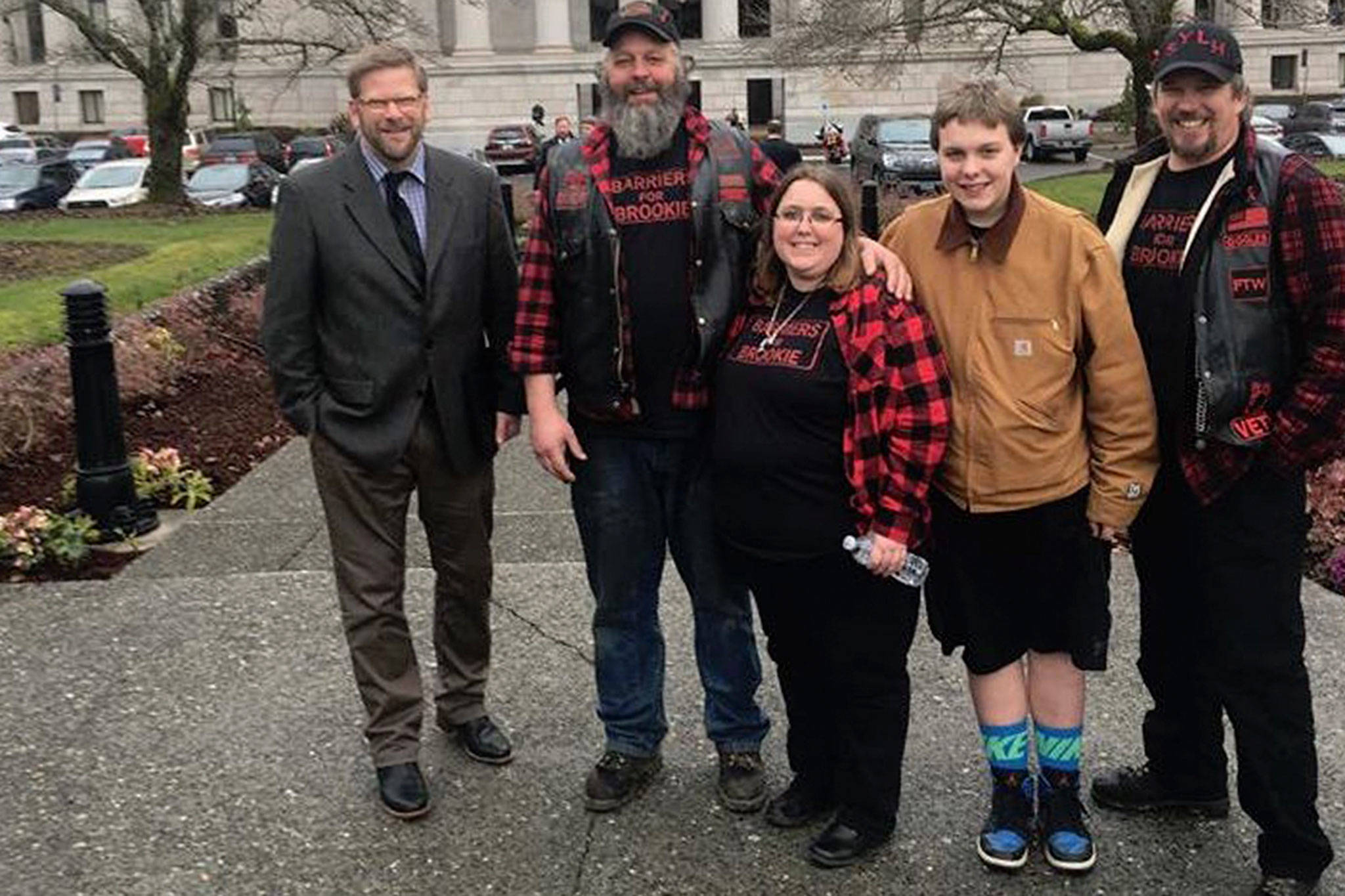 State Rep. Mike Chapman, far left, stands with the Bedinger family, from left, Don Bedinger, Kim Bedinger, Chase Bedinger and James Kirkpatrick in Olympia.