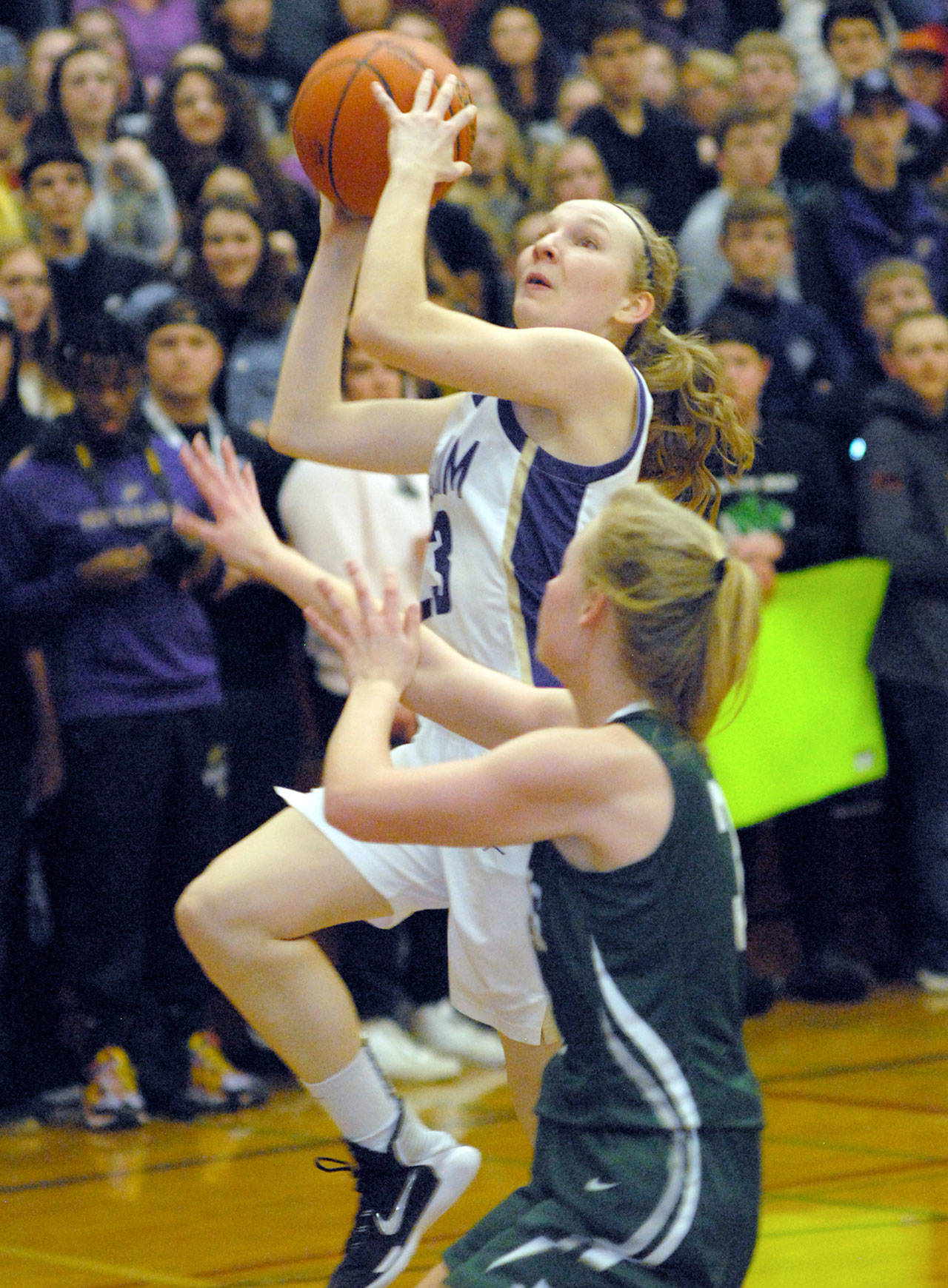 Keith Thorpe/Peninsula Daily News Sequim’s Melissa Porter goes for a layup as Port Angeles’ Summer Olsen holds down the lane on Friday at Sequim High School.