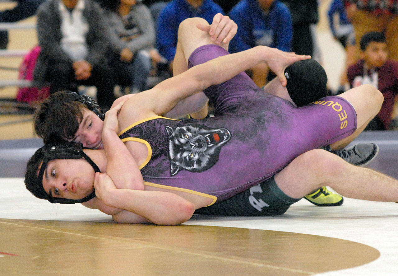 Keith Thorpe/Peninsula Daily News Sequim’s Zachery Koch, front, takes on Port Angeles’ Jackson Larson in the 145 lb. weight class in a semi-final round of the 2A Olympic League Sub-Regionals at Port Angeles High School on Saturday. Larson was victorious in the bout.