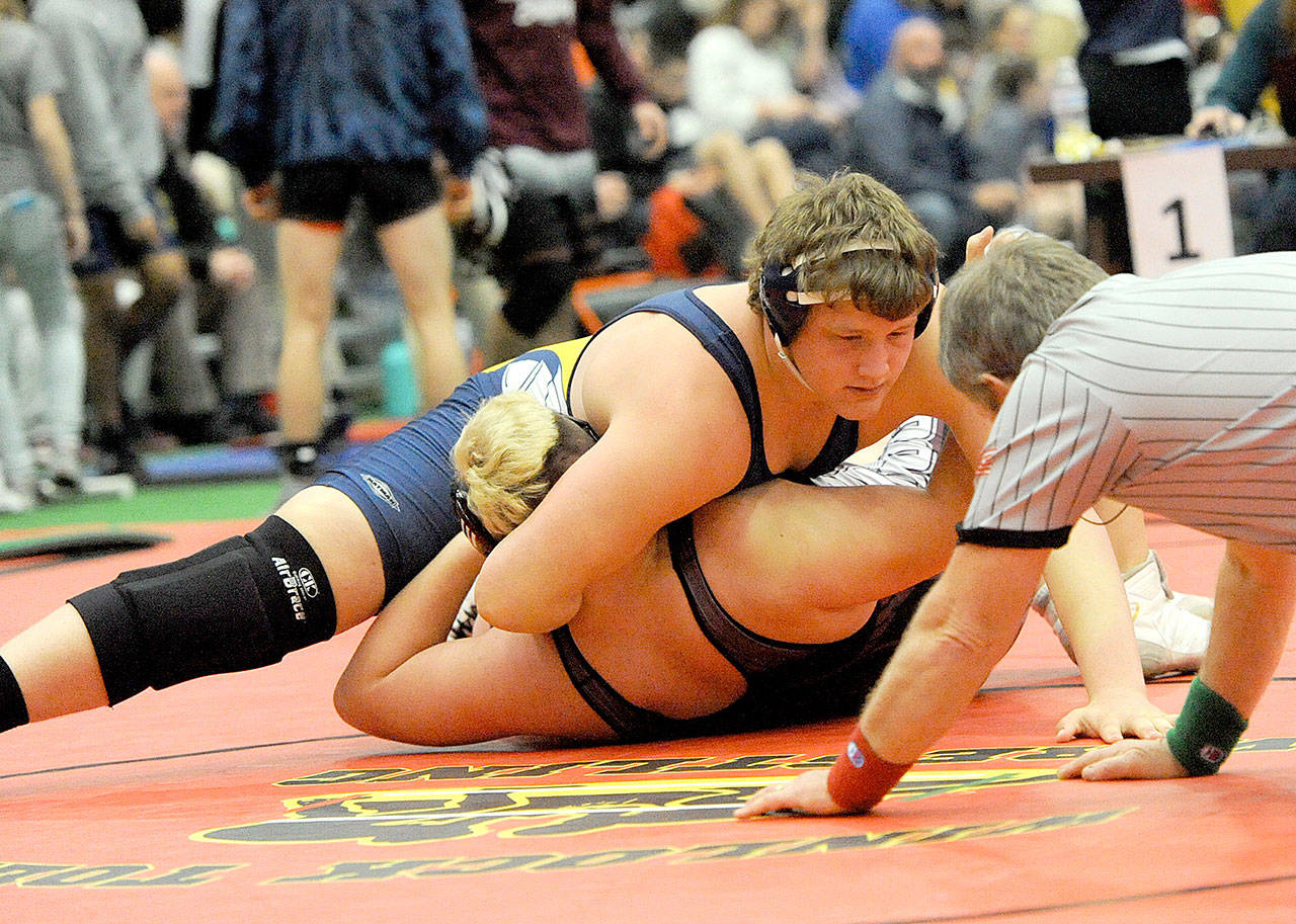Lonnie Archibald/for Peninsula Daily News Forks Luke Dahlgren pins Alejandro Hernandez of Elma to win a 1A Subregionals championship at 285 pounds at The Hub in Chehalis on Saturday.