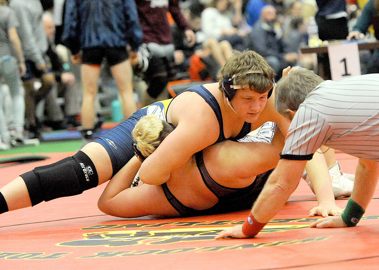 Lonnie Archibald/for Peninsula Daily News Forks’ Luke Dahlgren pins Alejandro Hernandez of Elma to win a 1A Subregionals championship at 285 pounds at The Hub in Chehalis on Saturday.