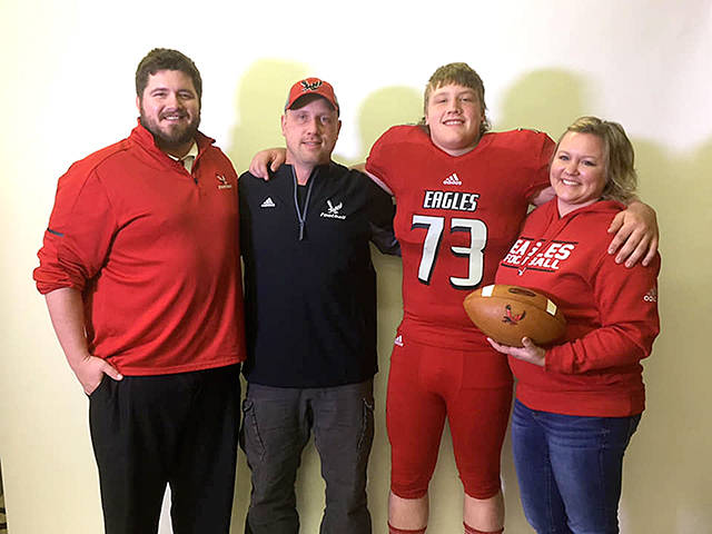 Forks’ Luke Dahlgren, third from left, recently visited and committed to play football for Eastern Washington University. He is joined by from left, EWU offensive line coach Jase Butorac, head coach Aaron Best and his mom Shannon Dahlgren.