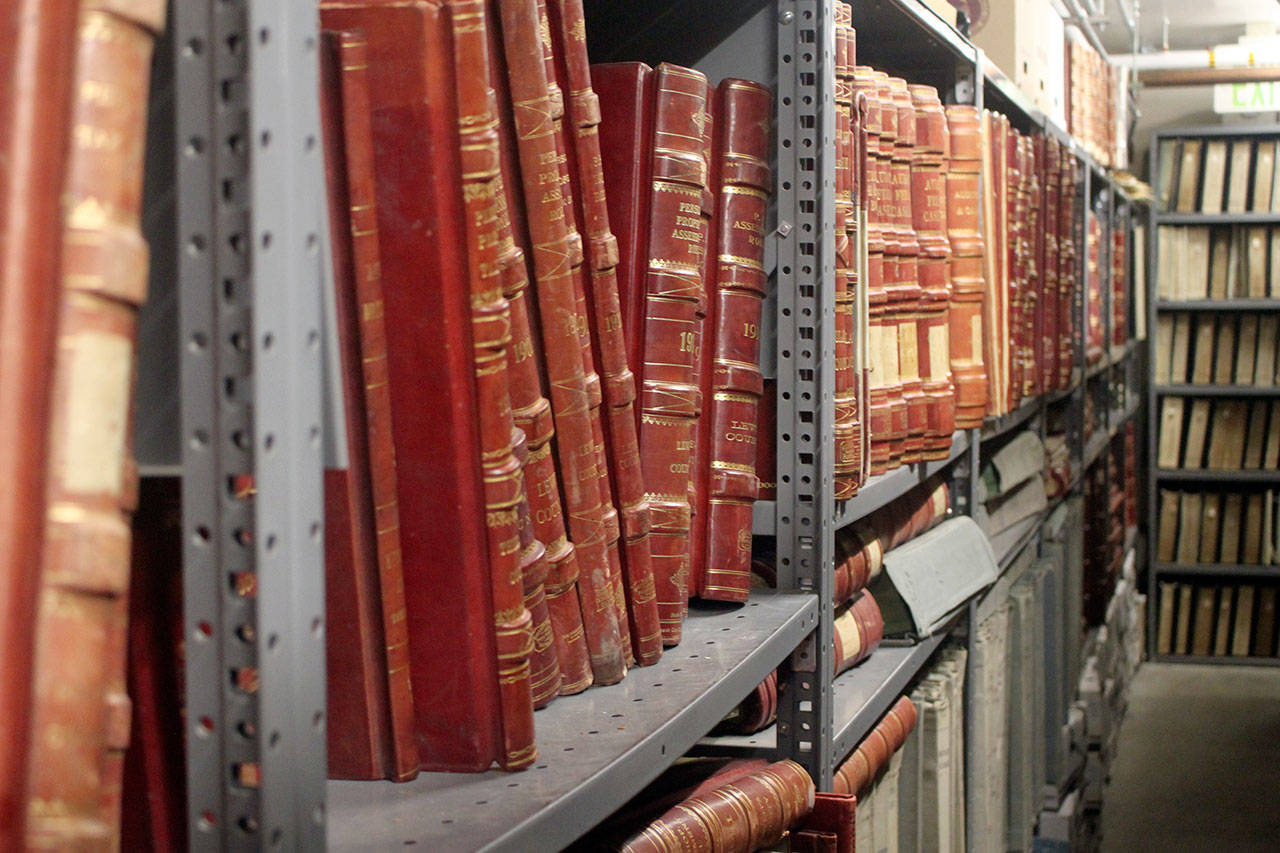 Bound volumes are county records stored in the State Archives building. Records have been damaged by water, but none were completely lost in the incidents. (Emma Scher/WNPA Olympia News Bureau)