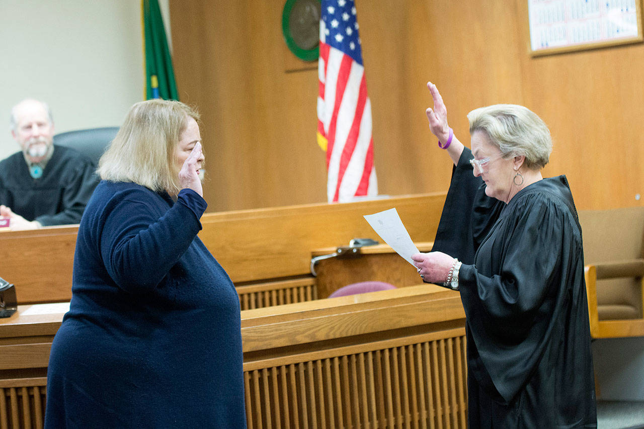 Washington State Supreme Court Justice Susan Owens, right, swears in Lauren Erickson as the first female Clallam County Superior Court judge. Gov. Jay Inslee appointed Erickson to replace Erik Rohrer, who left his post as Superior Court Judge when he was recently elected as District Court 2 judge. (Jesse Major/Peninsula Daily News)
