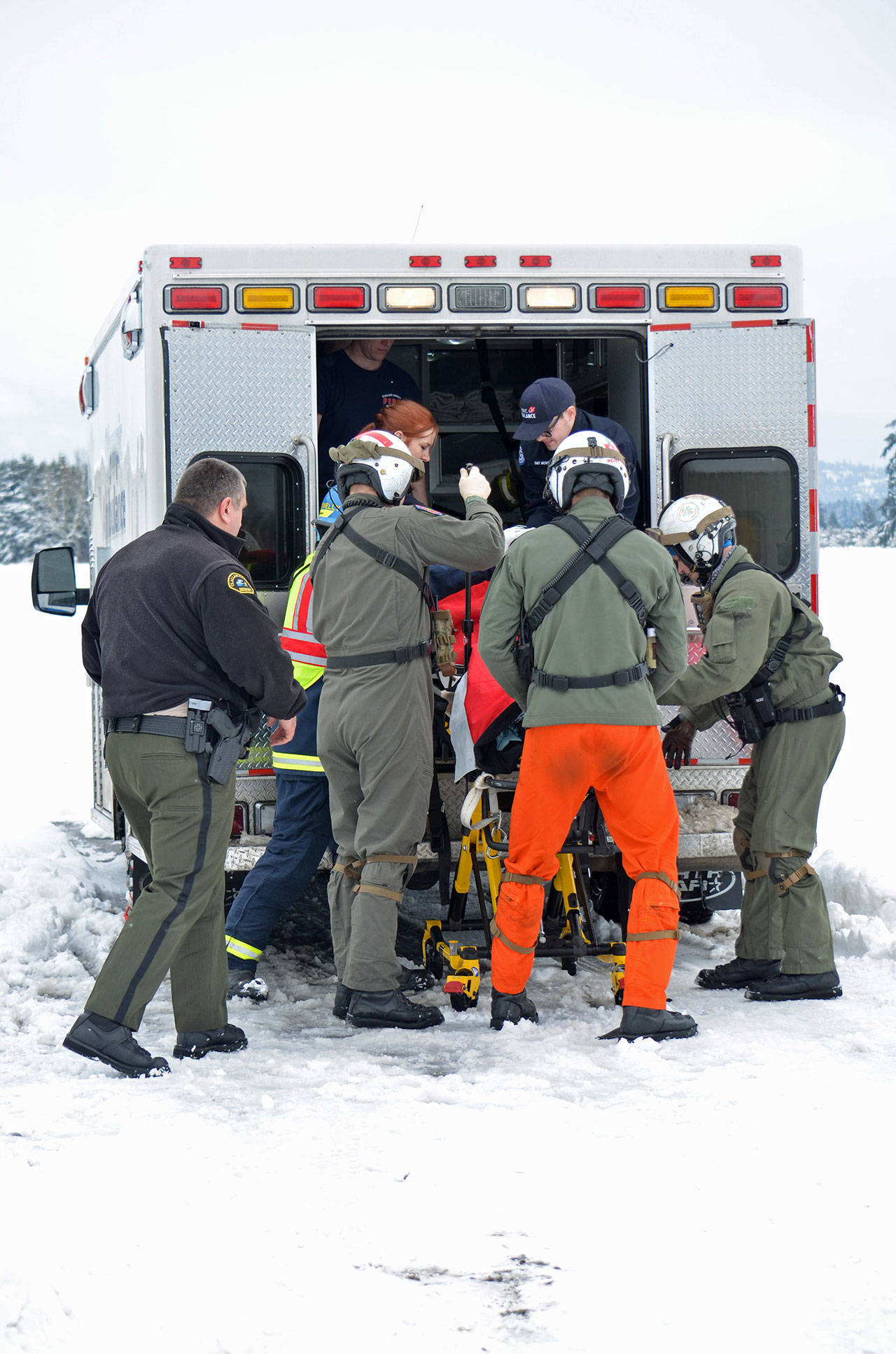 First responders load a man into an ambulance Monday after extricating him from beneath a collapsed roof. (Clallam County Fire District No. 3)