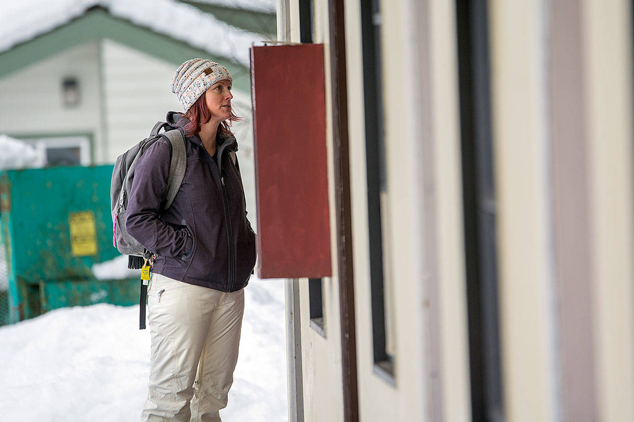 Amy Miller, who coordinates Volunteer in Medicine of the Olympics’ Rediscovery program, spent Tuesday morning talking with people who had been provided hotel rooms during the recent winter weather. (Jesse Major/Peninsula Daily News)