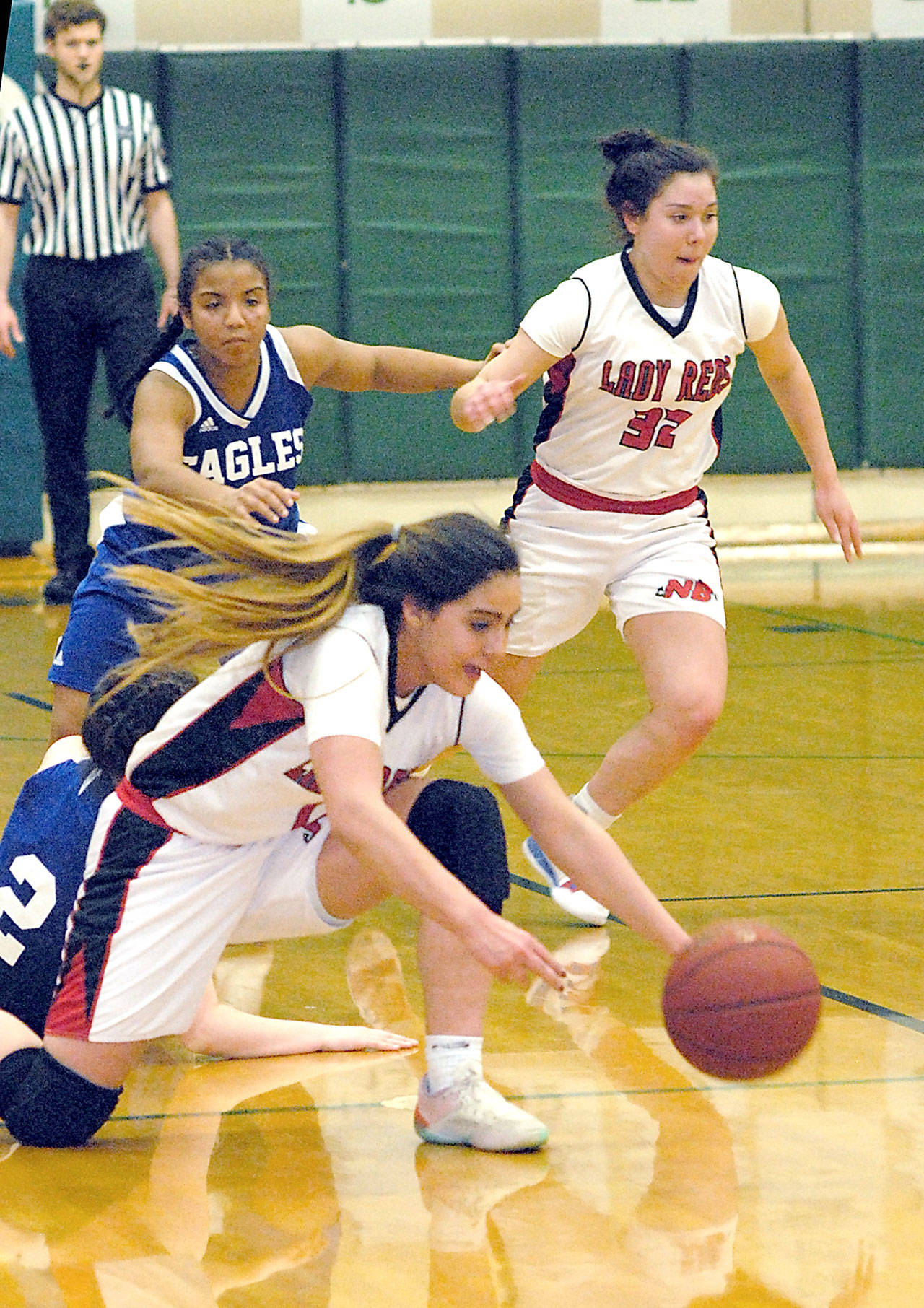 Keith Thorpe/Peninsula Daily News Neah Bay’s Courtney Swan, center, dives for the ball after tipping it from the grasp of Grace Academy’s Sabrina Metcalf, on floor, as Grace Academy’s Emily Fredrickson and Neah’ Bay’s Ruth Moss, right, chase from behind on Friday at Port Angeles High School.