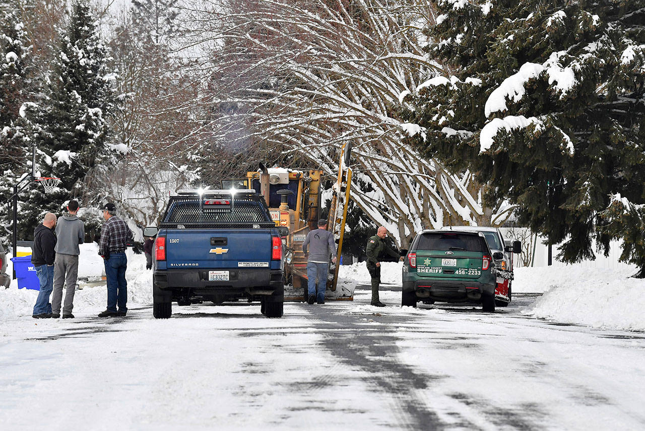 Wednesday, Spokane County Sheriff’s deputies respond to a call where a Spokane County plow driver said a local man brandished a firearm and told him to step out of his plow in Spokane. (Tyler Tjomsland/The Spokesman-Review via The Associated Press)