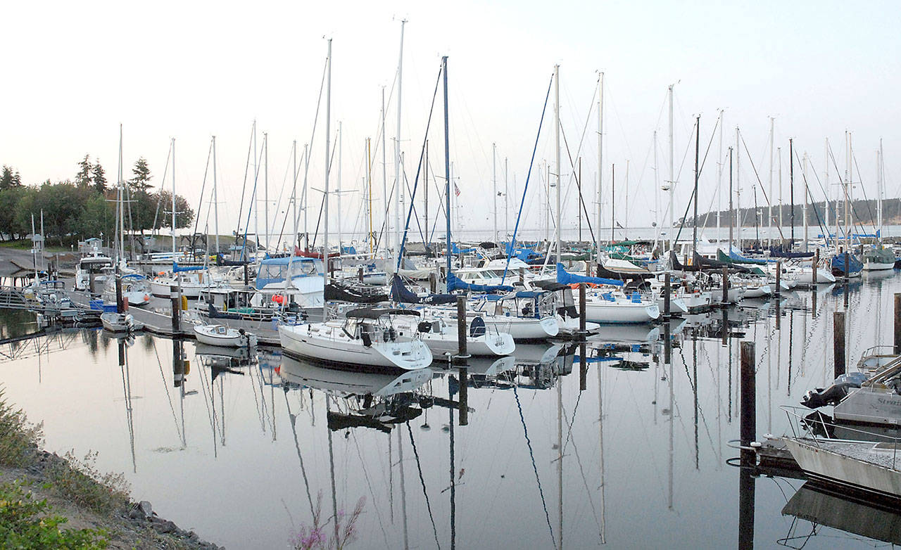 Boats sit on placid water at John Wayne Marina in Sequim. (Keith Thorpe/Peninsula Daily News)