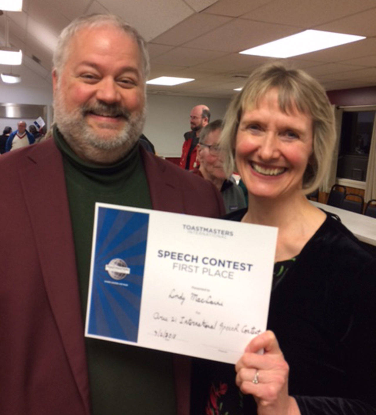 Lindy MacLaine, last year’s District 32 Toastmasters champion, celebrates her win in 2018 with District 32 Director Kyle Hall.