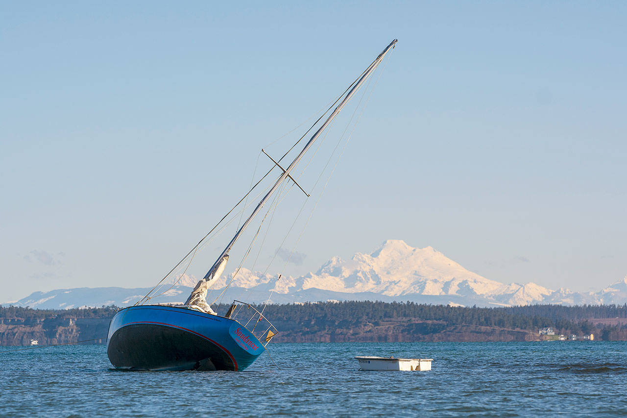 The Sundancer, a 30-foot sailboat from Port Ludlow, remained stuck in a sandbar at Port Hudson in Port Townsend on Thursday morning. (Jesse Major/Peninsula Daily News)