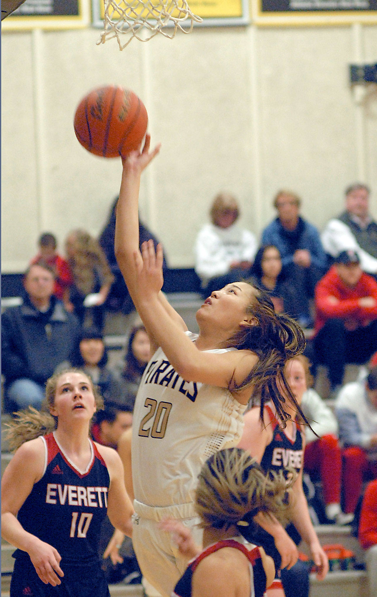 Keith Thorpe/Peninsula Daily News Peninsula’s Logan Luke, center, shoots for the hoop surrounded by Everett defenders, from left, Morgan Marshall, Serafina Balderas and Kelsey Mellick on Saturday in Port Angeles.