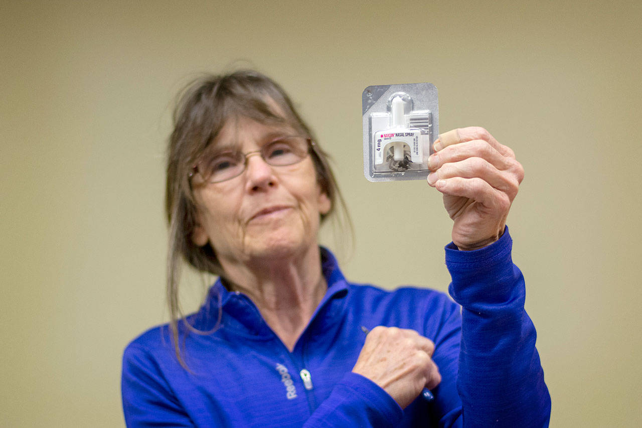Clallam County Health and Human Services nurse Ann Johnson holds up Narcan during a presentation Monday night. (Jesse Major/Peninsula Daily News)