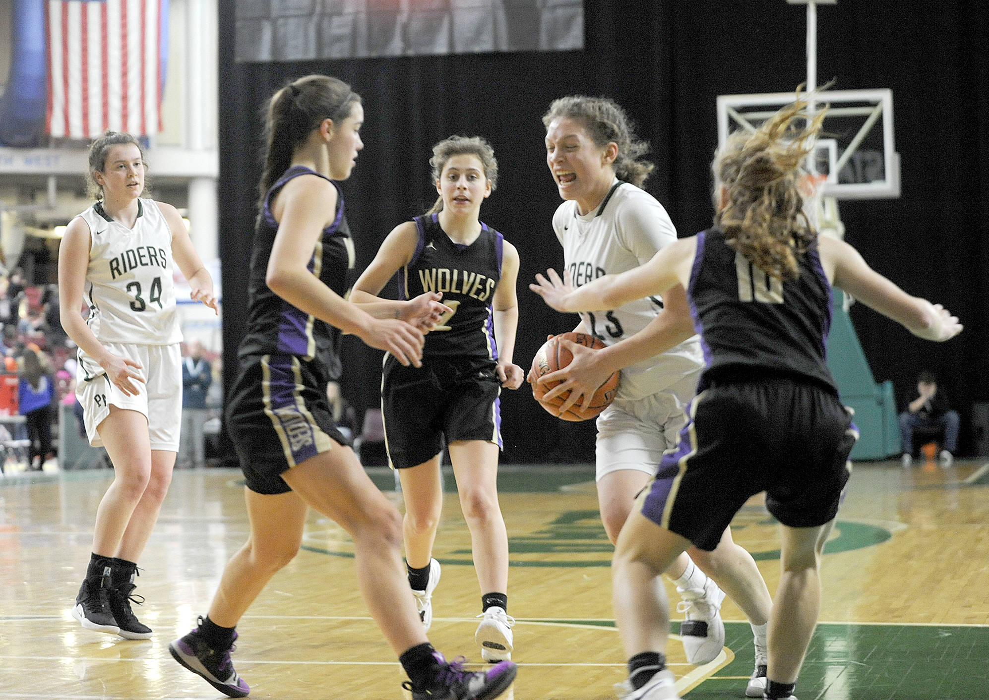 &lt;strong&gt;Michael Dashiell&lt;/strong&gt;/Olympic Peninsula News Group                                Port Angeles’ Madison Cooke, second from right, drives while defended by Sequim’s Hope Glasser, Jessica Dietzman and Riley Pyeatt during the Roughriders’ 57-47 state tournament victory over the Wolves.