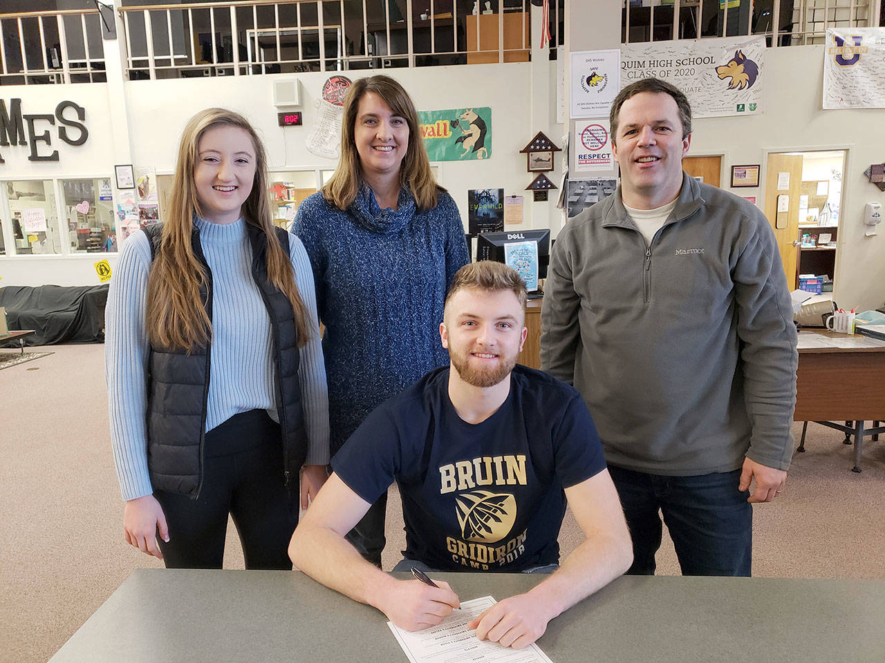 Sequim senior quarterback Riley Cowan has signed a letter of intent to play football at George Fox University. Riley is joined in the photo by his family from left, sister Brianna Cowan, mom Heather Cowan, and dad Dave Cowan.
