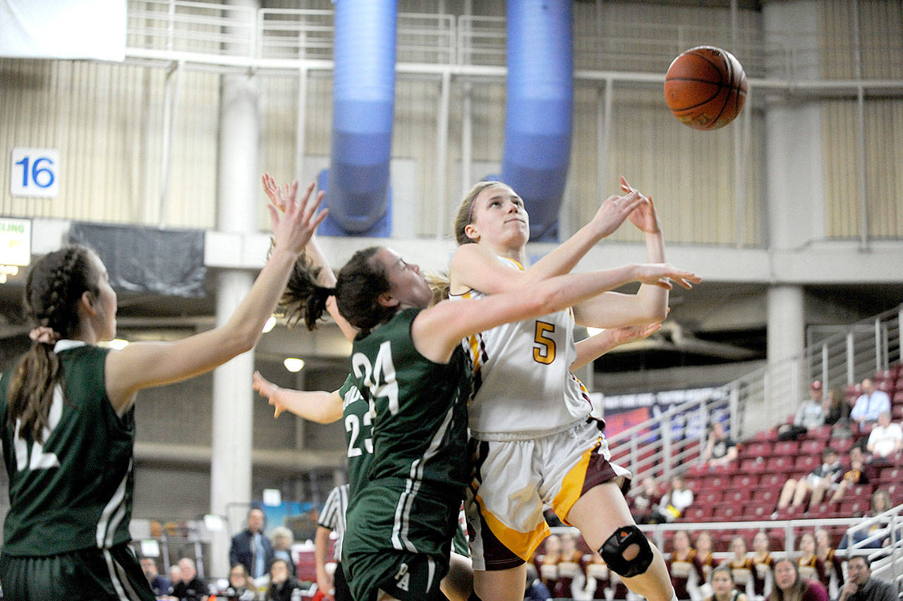 Port Angeles’ Jaida Wood, center, fouls White River’s Emma Robbins in the first half of the Roughriders’ 60-55 state quarterfinal loss to White River on Thursday at the Yakima SunDome. Michael Dashiell/Olympic Peninsula News Group