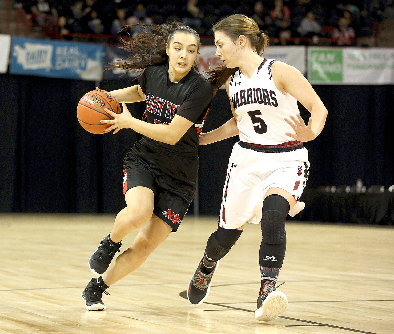 CeiJ Gagnon drives the ball against ACHs Sarah Bradshaw in the girls 1B third-place game Saturday in Spokane. Gagnon scored 12 points as the Red Devils won 67-56 to finish third, the highest girls finish ever at state. (Chris Johnson/for Peninsula Daily News)