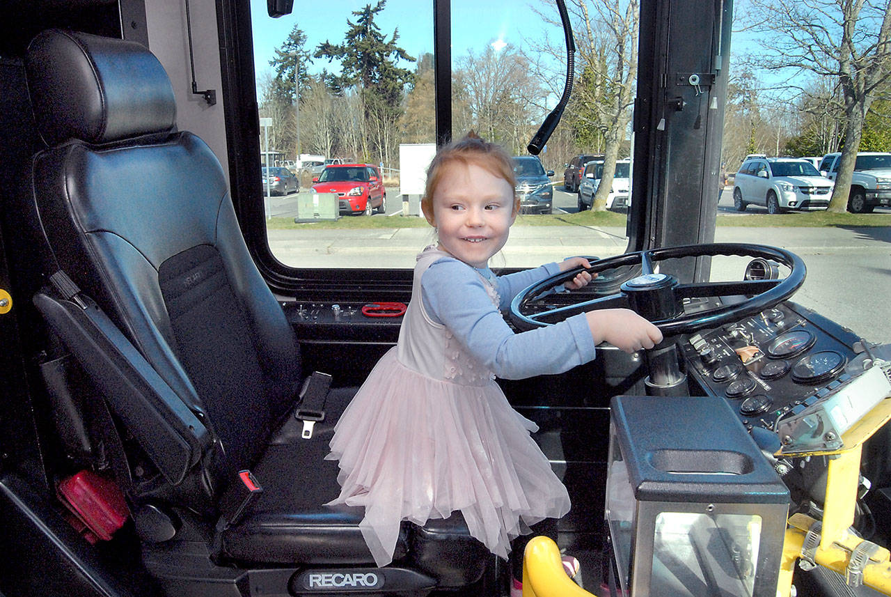 Four-year-old Dawn Nunmson of Port Angeles takes her turn pretending to drive a Clallam Transit bus during Kidsfest 2019 at and outside of Vern Burton Community Center on Saturday in Port Angeles. (Keith Thorpe/Peninsula Daily News)