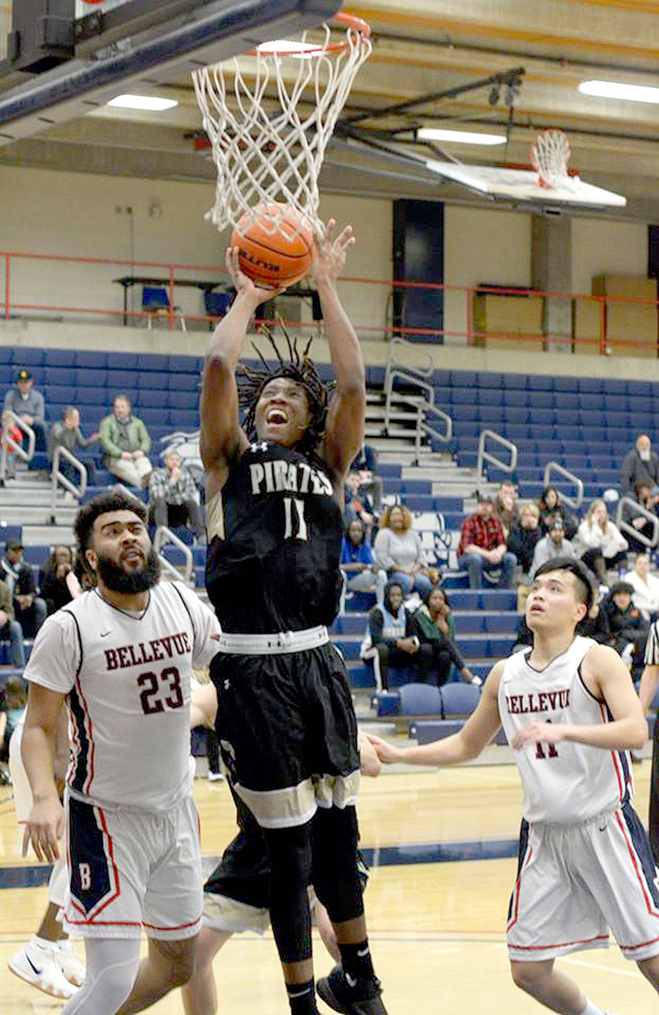 Rick Ross Peninsula’s Malik Moore grabs one of his 15 rebounds against Bellevue College as the Pirates won 69-68 to qualify for the NWAC Tournament.