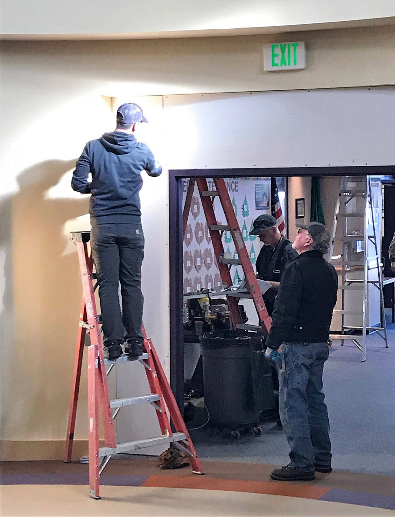 A Port Angeles School District maintenance crew works on installing controlled access to a school entry. From left are Josh Winters on the ladder and Ron Erdmann in front with Bob Anderson in back. (Nolan Duce/Port Angeles School District)