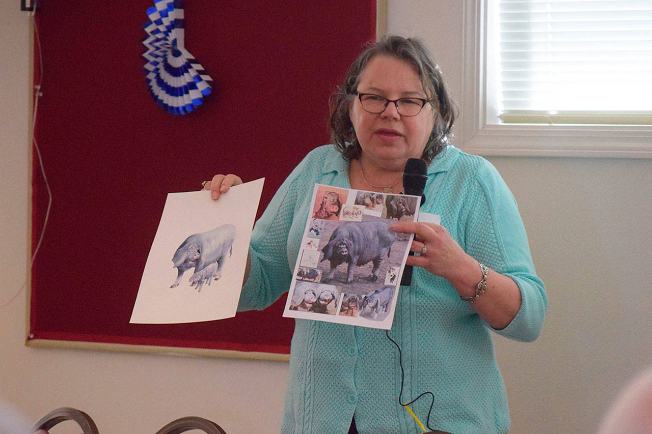 Animation and watercolor artist Carolyn Guske demonstrates her work at a recent Olympic Peninsula Arts Association monthly meeting. (Erin Hawkins/Olympic Peninsula News Group)
