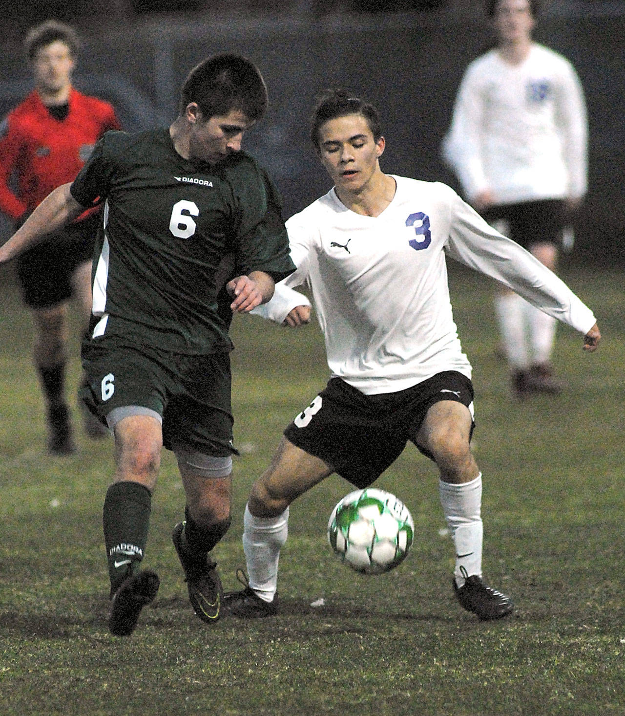 Keith Thorpe/Peninsula Daily News Port Angeles’ Kaleb Baier, left, and Sequim’s Ryan Tolberd battle for ball control during Tuesday night’s match at Port Angeles Civic Field.