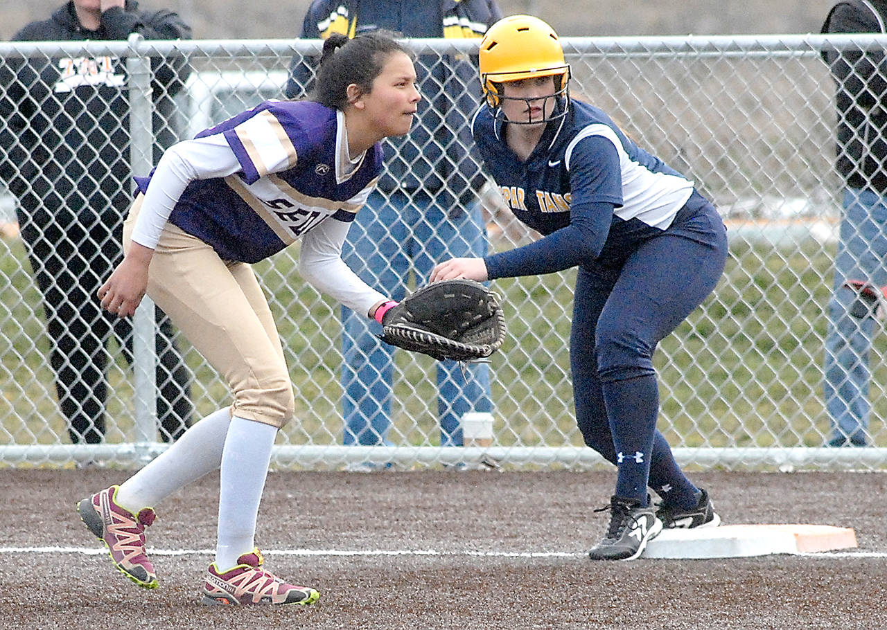 Keith Thorpe/Peninsula Daily News Sequim first baseman Latisha Robideau, left, watches home as Forks’ Rian Peters looks for a chance to steal in the first inning at Billie Whiteshoes Memorial Park in Port Angeles.