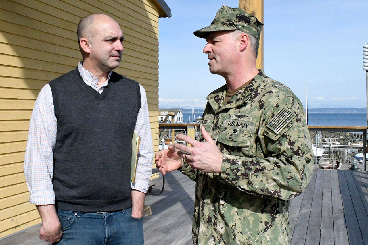 The Northwest Maritime Center’s Jake Beattie talks with Navy Rear Admiral Scott Gray, commander of the Northwest Region, about a new high school program planned for fall. The Skills Center Initiative will be open to students in Jefferson, Clallam and Kitsap counties and is an extension of the Port Townsend School’s Maritime Discovery School program held at the Center. (Jeannie McMacken/Peninsula Daily News)