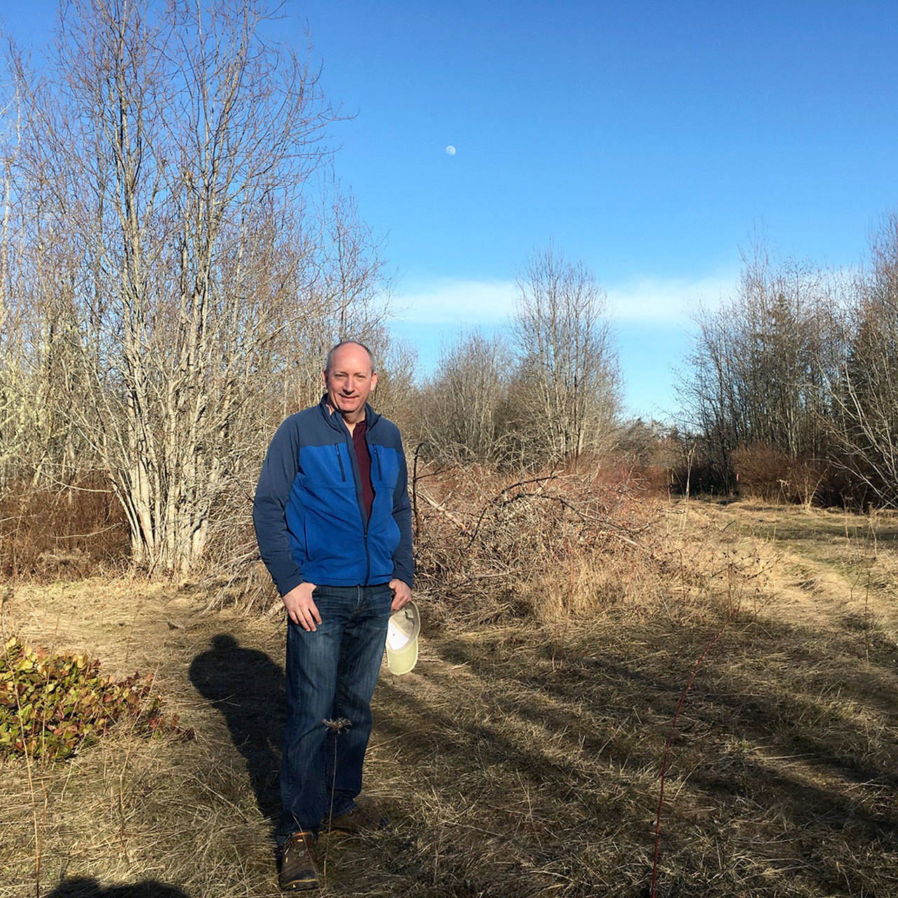 Matthew Rainwater, founder and president of Pennies for Quarters, stands at the future site of a tiny home community for homeless veterans. The nonprofit has purchased the Devanny Lane site near Port Angeles. (Rob Ollikainen/Peninsula Daily News)