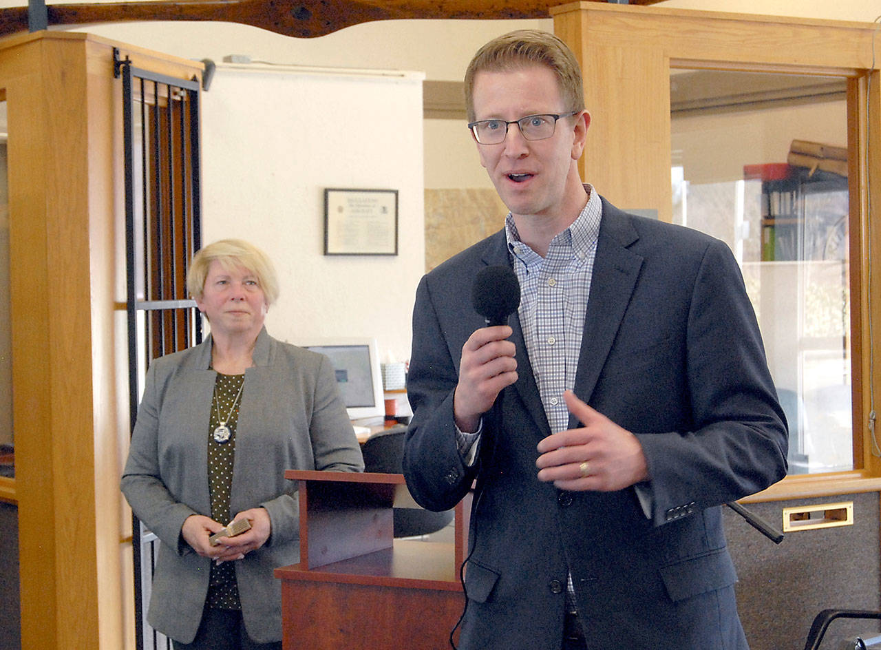 U.S. Rep. Derek Kilmer, D-Gig Harbor, speaks at a presentation about the community importance of William R. Fairchild International Airport in Port Angeles as Port of Port Angeles Commissioner Connie Beauvais listens. (Keith Thorpe/Peninsula Daily News)